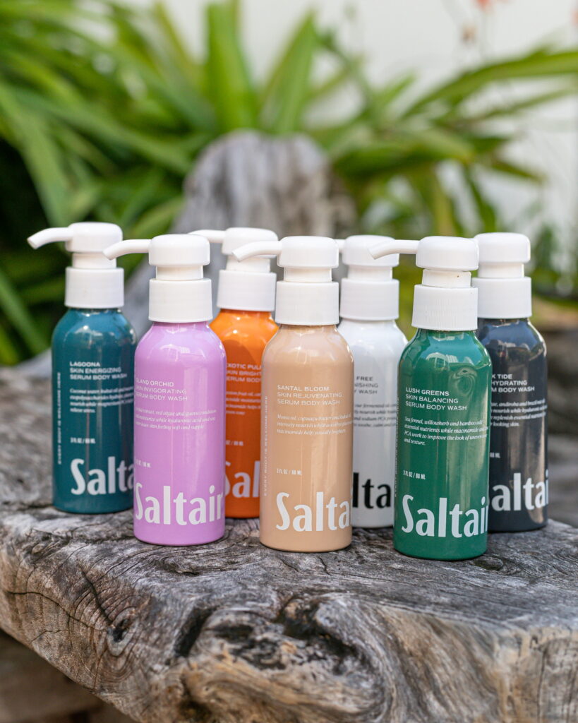 Saltair serum body wash variety on a piece of wood.