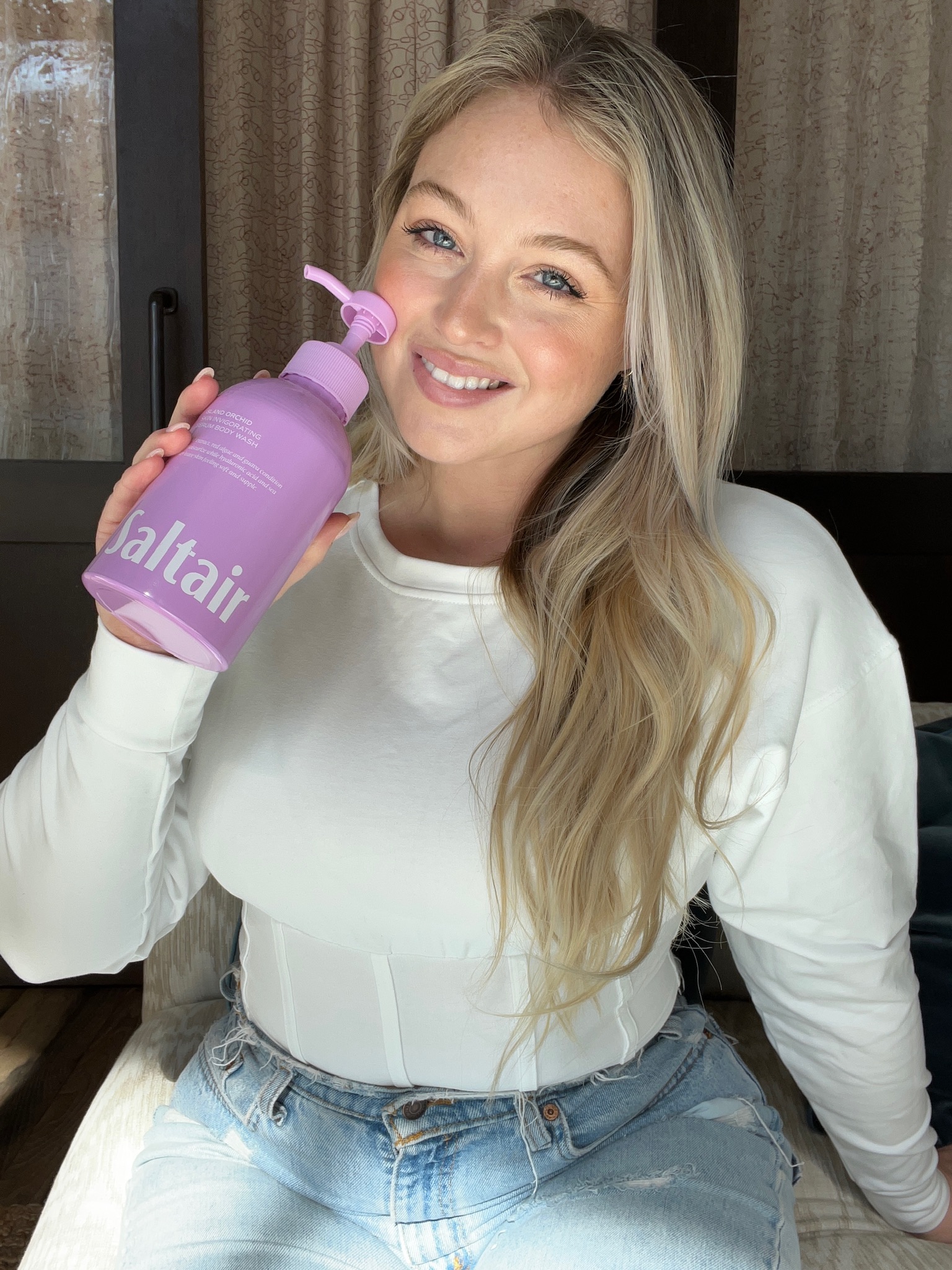 Iskra holding a Saltair body wash (island orchid scent)
